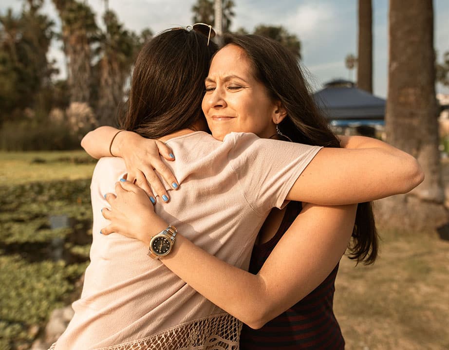 hugging two women hugging each other