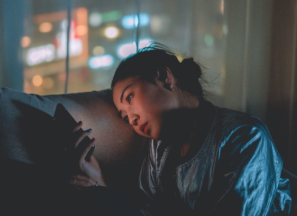 woman up late looking at cell phone