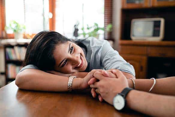 woman holding hands and smiling