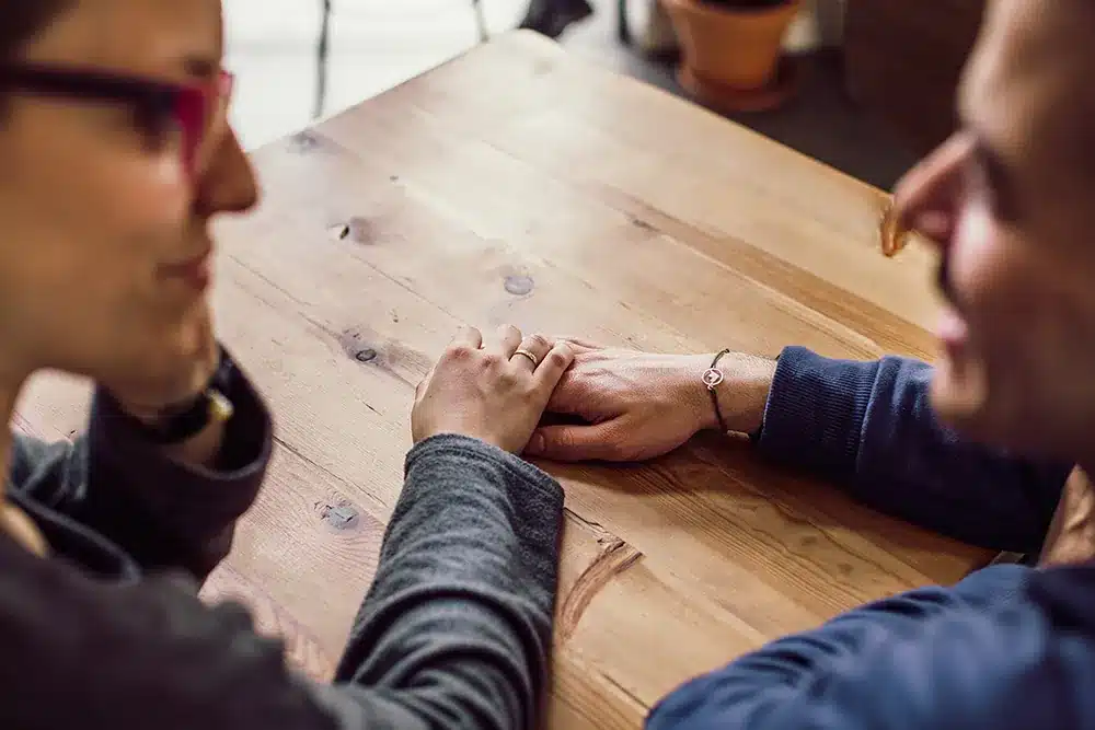 two people holding each other's hands