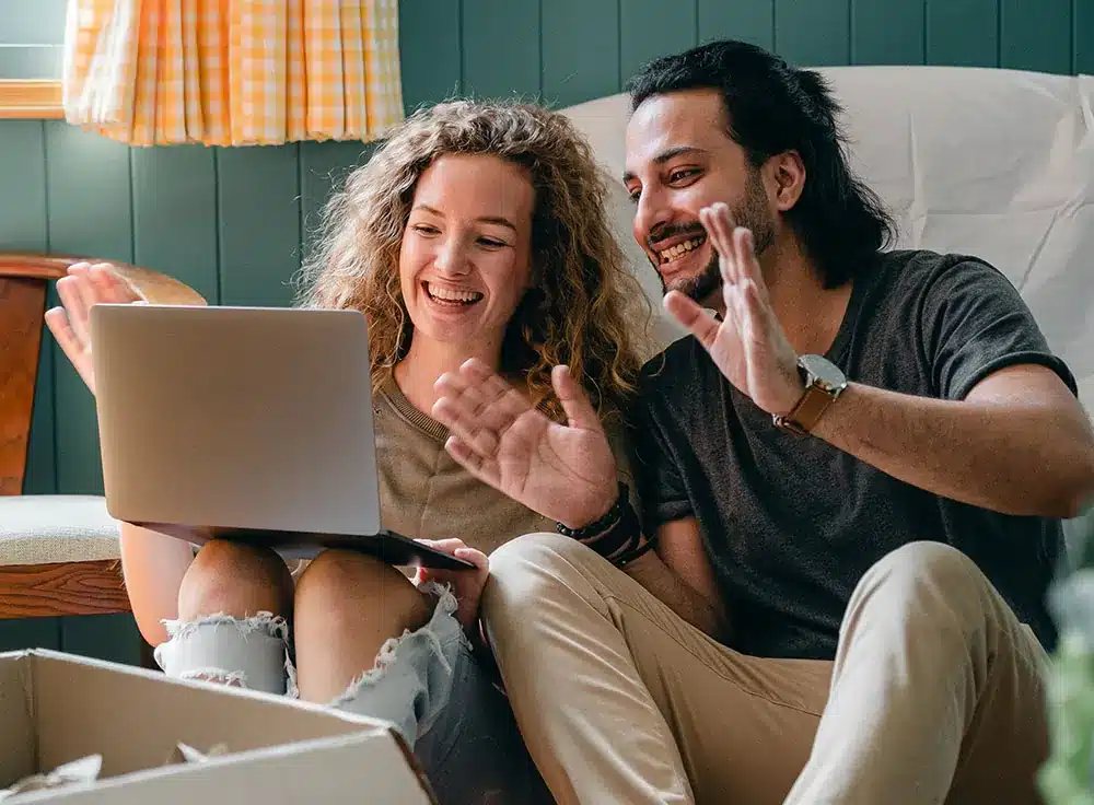 man and woman smiling and waving