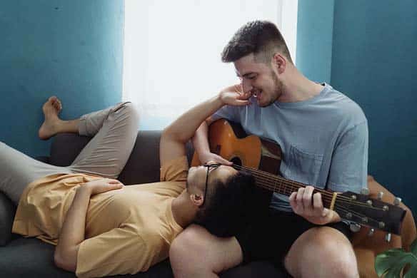 couple playing guitar and singing casually